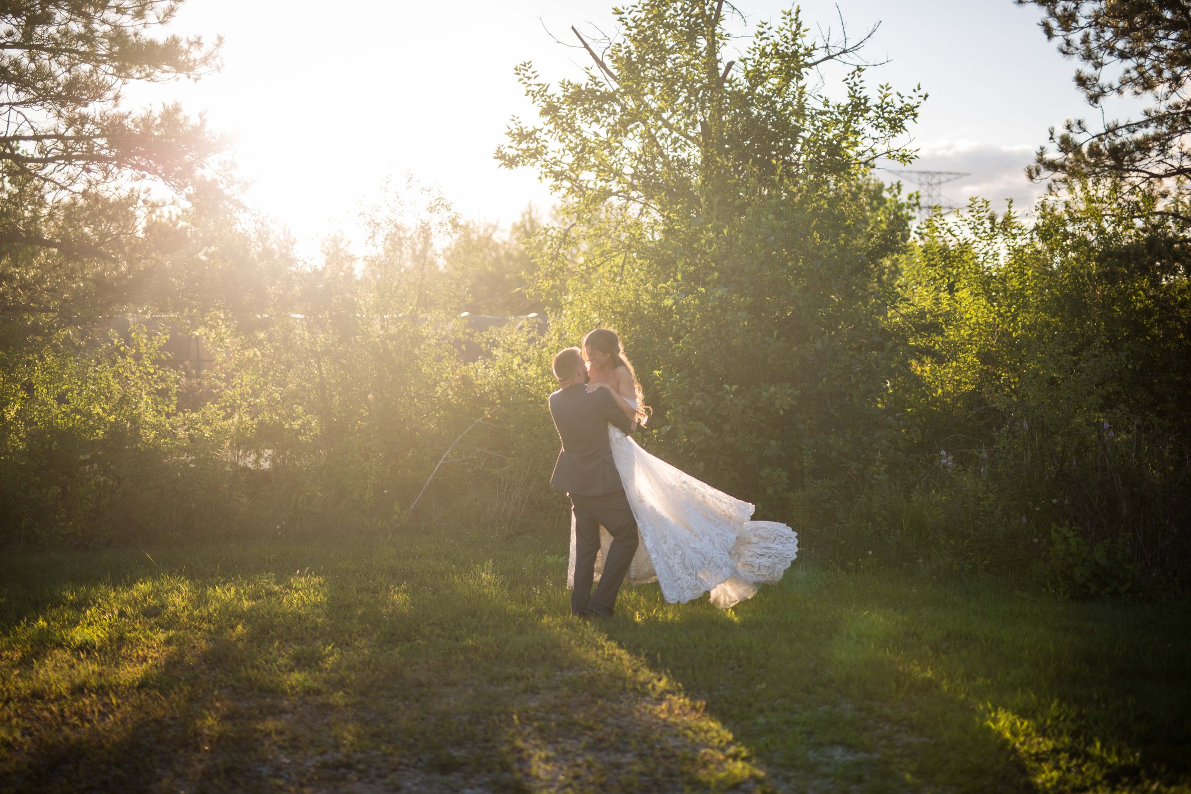 Rebecca and Nick walking together through the gardens on their wedding day