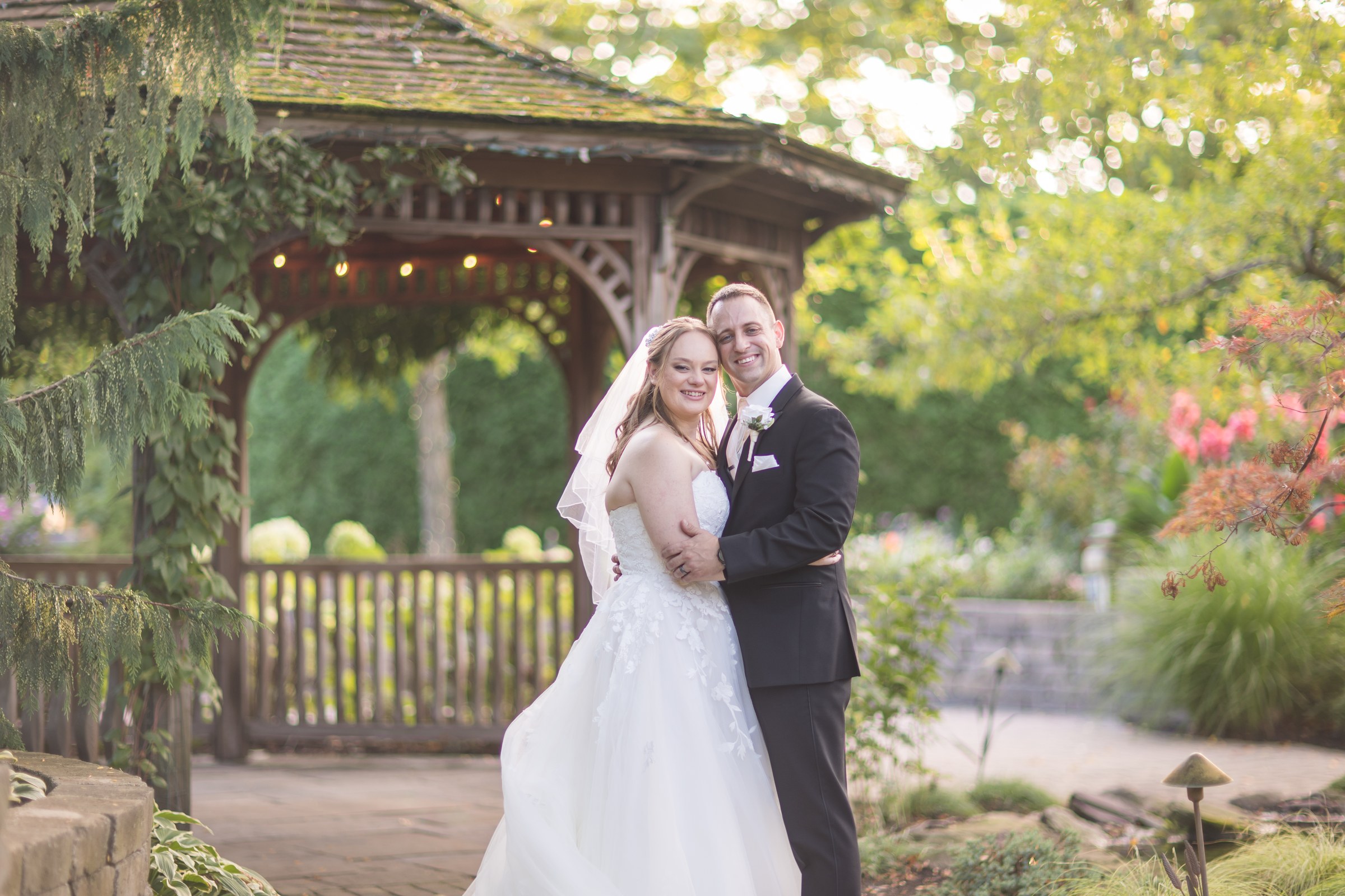 Paige and TJ together in the gardens at Gardens of Woodstock on their wedding day